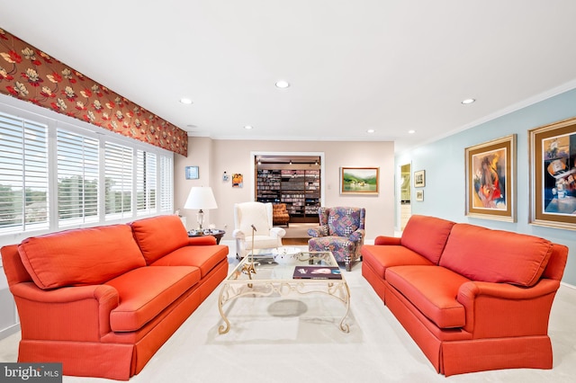 living area with crown molding and recessed lighting