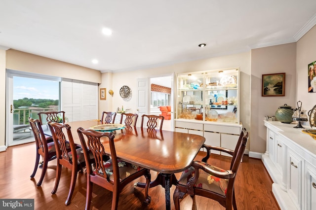 dining area with plenty of natural light, ornamental molding, wood finished floors, and recessed lighting