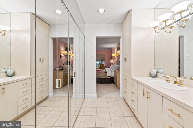 full bath featuring tile patterned flooring, recessed lighting, a notable chandelier, vanity, and ensuite bath