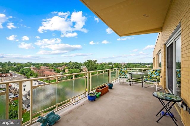 balcony with a water view and a sunroom