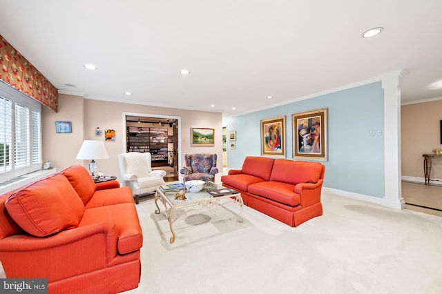 carpeted living area featuring baseboards, ornamental molding, recessed lighting, and ornate columns