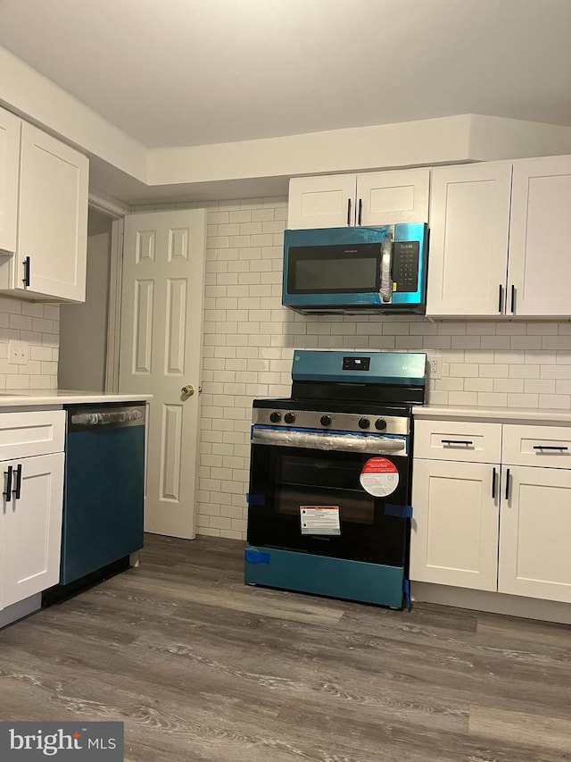 kitchen featuring appliances with stainless steel finishes, white cabinets, and dark hardwood / wood-style floors