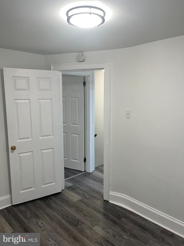 spare room featuring dark hardwood / wood-style floors