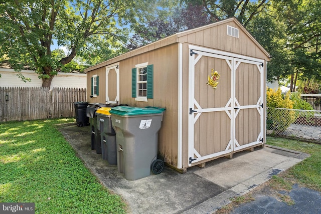 view of outbuilding featuring a yard