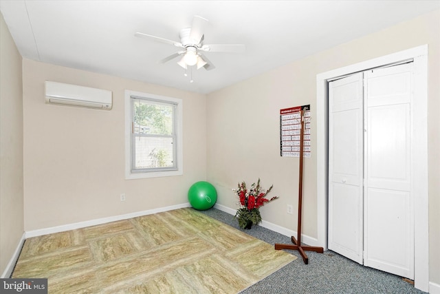 workout area featuring a wall mounted AC and ceiling fan