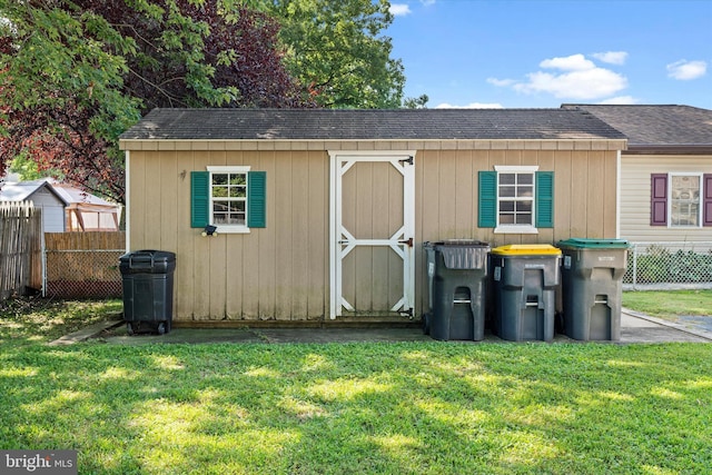 view of front of house with a shed and a front lawn