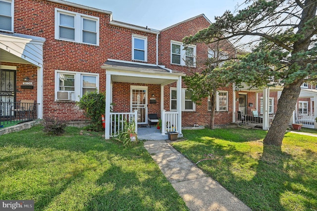 multi unit property featuring cooling unit, a porch, and a front yard