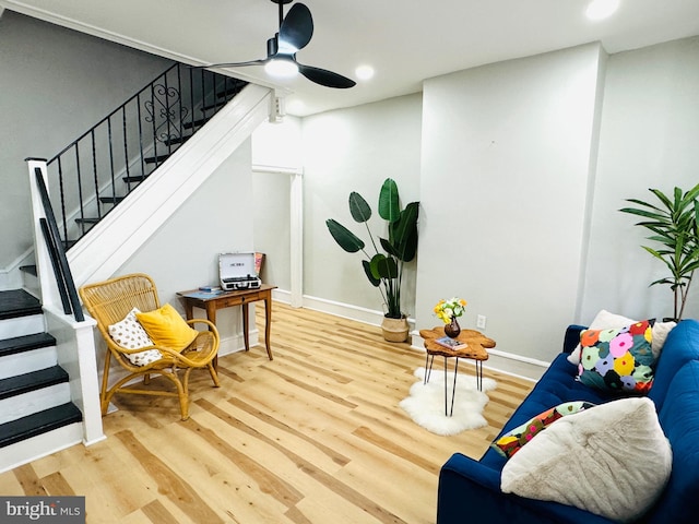 living area with ceiling fan and wood-type flooring