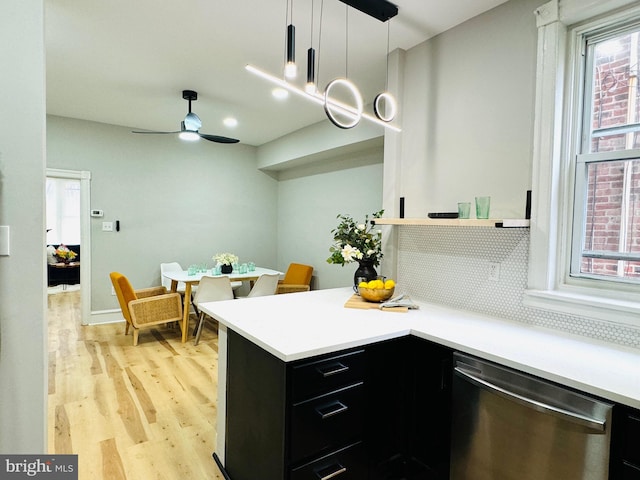 kitchen with ceiling fan, stainless steel dishwasher, pendant lighting, light hardwood / wood-style floors, and decorative backsplash