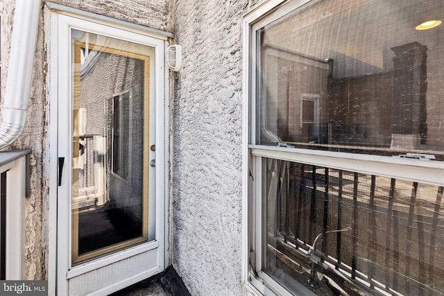 doorway to property with stucco siding