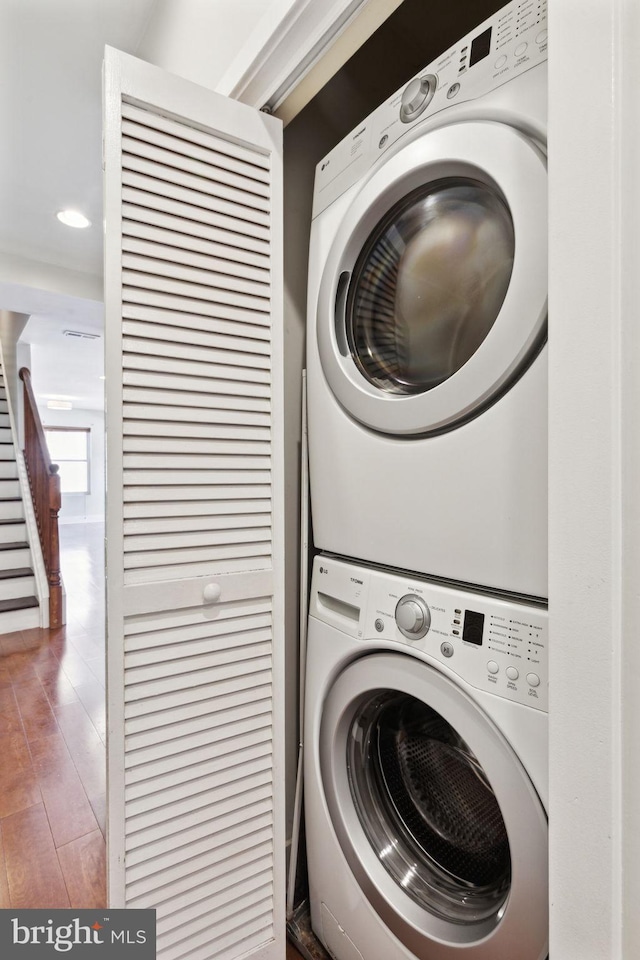 laundry area with stacked washer and dryer and laundry area