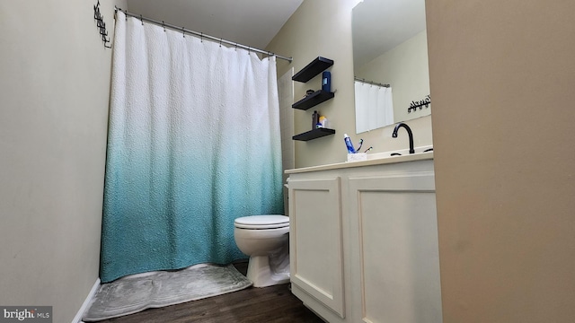 bathroom featuring hardwood / wood-style floors, toilet, and vanity