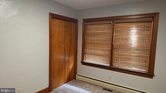 interior space featuring a baseboard radiator and carpet floors