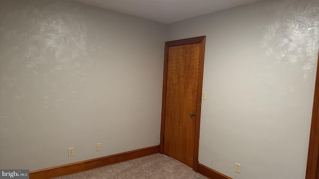 spare room with light colored carpet