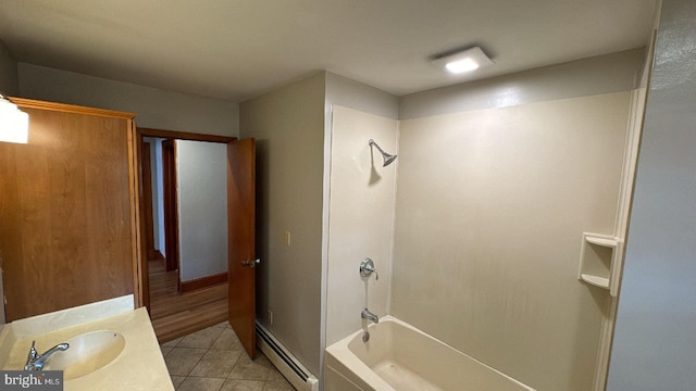 bathroom with vanity, tile patterned floors, a baseboard heating unit, and tub / shower combination