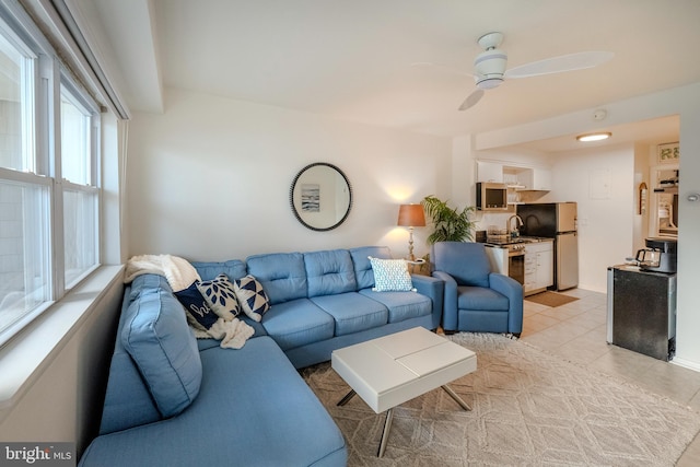 tiled living room featuring ceiling fan