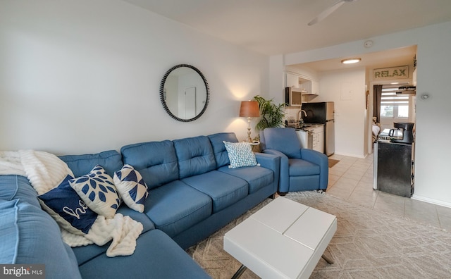 tiled living room featuring ceiling fan