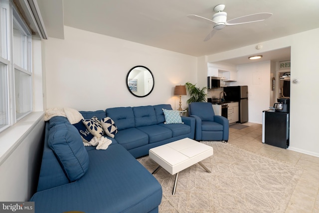 tiled living room with ceiling fan