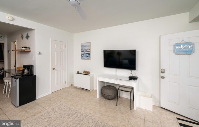 living room featuring ceiling fan and light tile patterned floors