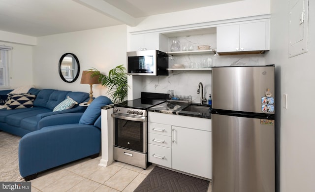 kitchen featuring white cabinetry, stainless steel appliances, sink, and decorative backsplash