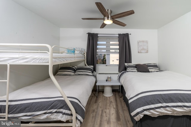 bedroom featuring wood-type flooring and ceiling fan