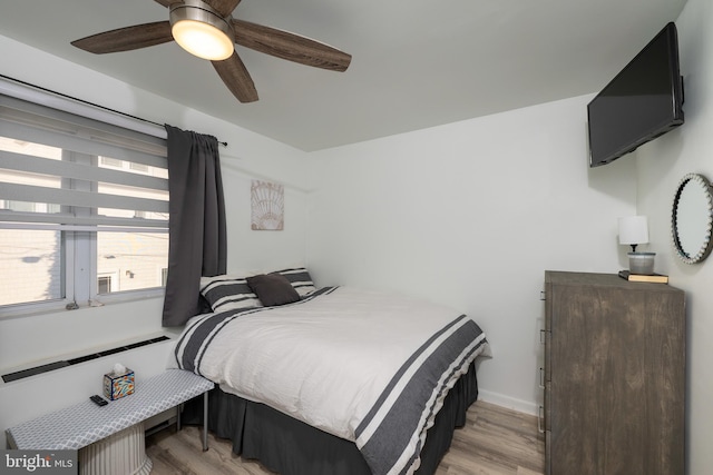 bedroom with ceiling fan and light hardwood / wood-style floors