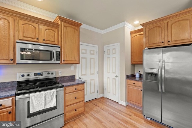 1159 Stoney Bottom Rd, Front Royal, VA 22630 - kitchen featuring appliances with stainless steel finishes, crown molding, light wood finished floors, recessed lighting, and dark stone counters