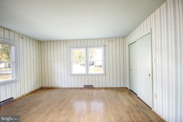 empty room with light hardwood / wood-style flooring