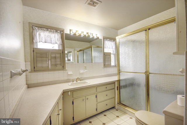 bathroom featuring walk in shower, vanity, decorative backsplash, tile patterned flooring, and toilet