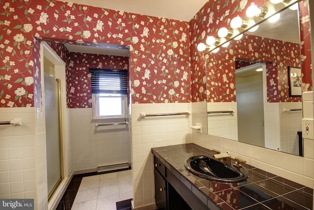 bathroom with vanity, tile walls, tile patterned flooring, and a shower with shower door