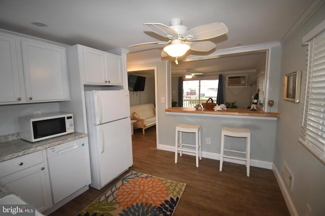 kitchen featuring a wall unit AC, white cabinetry, white appliances, dark hardwood / wood-style flooring, and ceiling fan