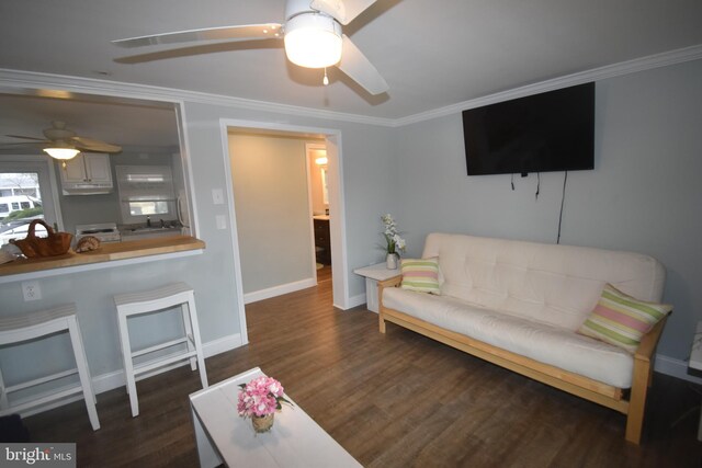 living room with ornamental molding, dark hardwood / wood-style flooring, sink, and ceiling fan