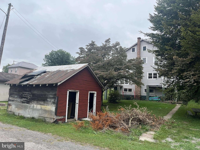 view of outbuilding with a yard