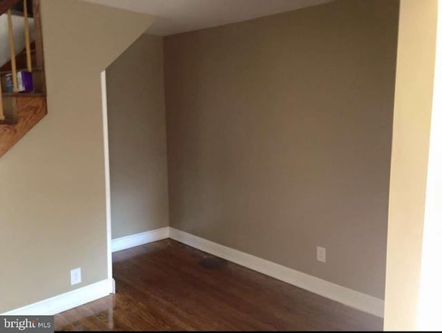 unfurnished room with dark hardwood / wood-style floors