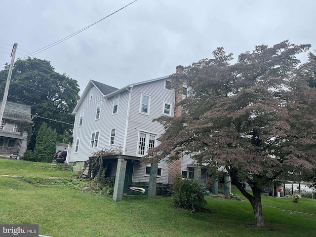 view of property exterior with a lawn