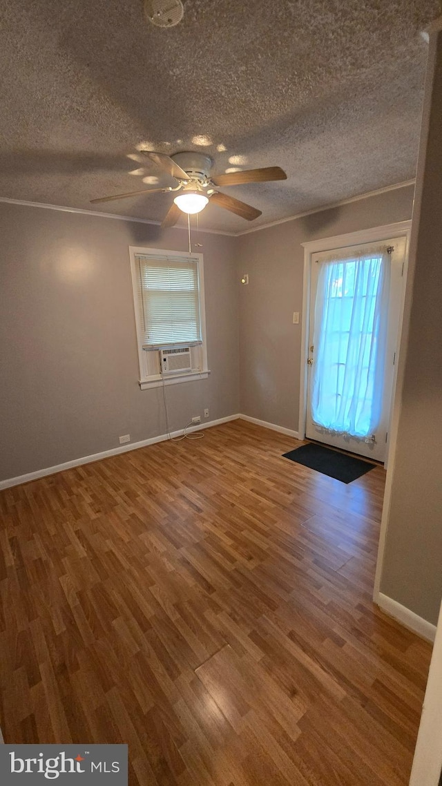 interior space featuring ornamental molding, ceiling fan, hardwood / wood-style flooring, and a textured ceiling