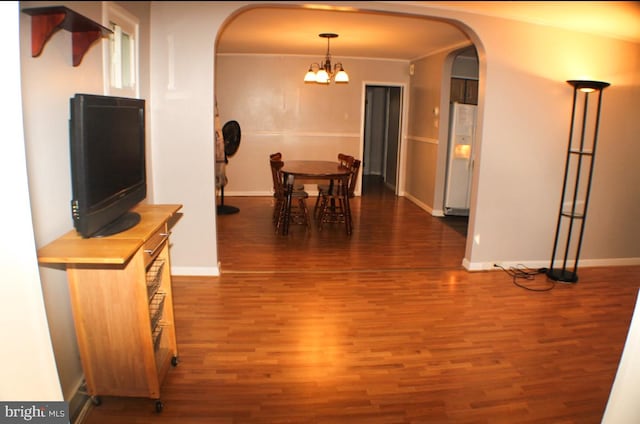 dining space with ornamental molding, dark hardwood / wood-style floors, and a chandelier