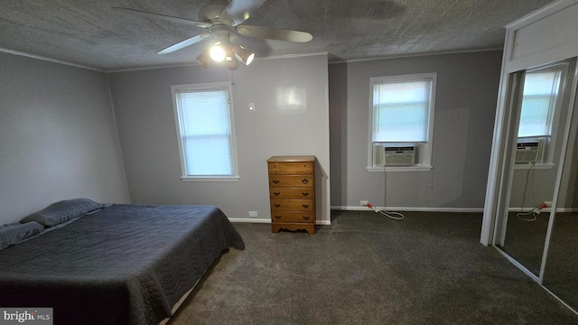 carpeted bedroom featuring ceiling fan, multiple windows, and a textured ceiling