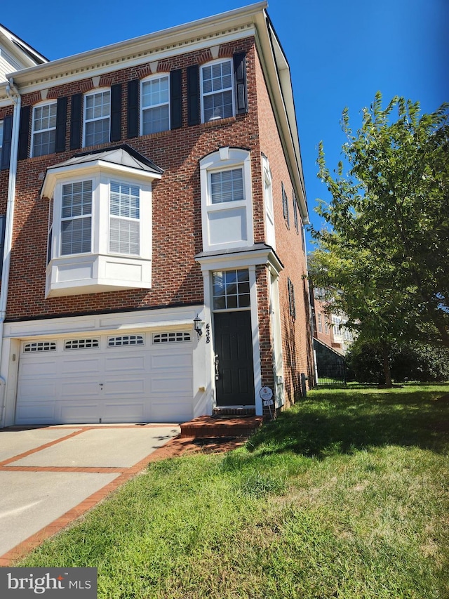 view of front facade with concrete driveway, brick siding, and a front lawn