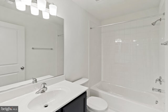 full bathroom with vanity, toilet, and tiled shower / bath