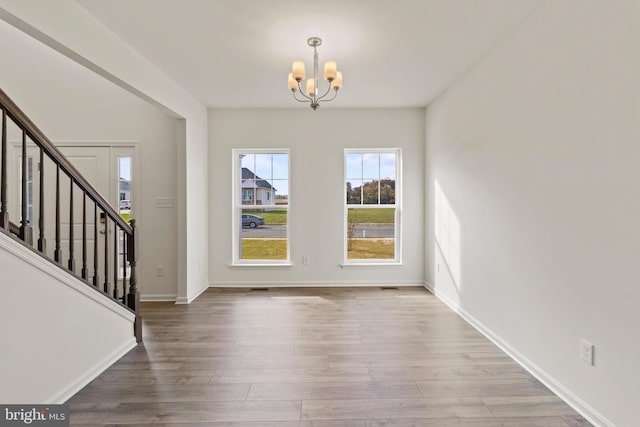 entryway featuring hardwood / wood-style floors and a chandelier