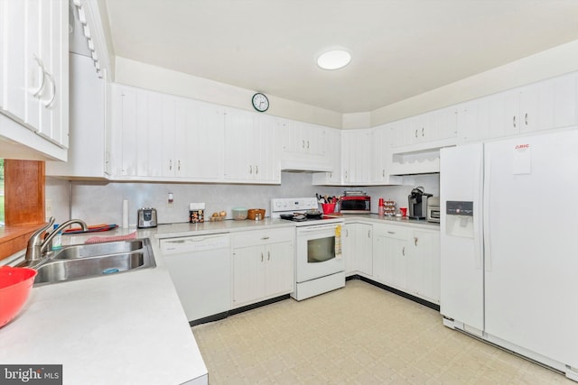 kitchen with white appliances, sink, and white cabinetry