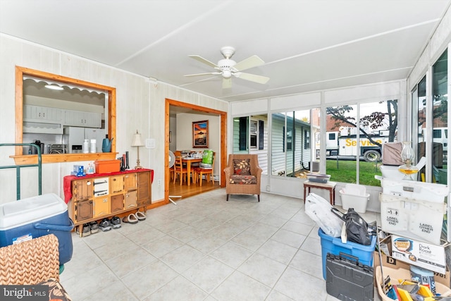 sunroom / solarium featuring ceiling fan