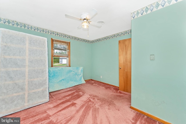 carpeted empty room with ceiling fan