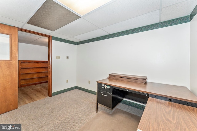 home office with a paneled ceiling and light colored carpet