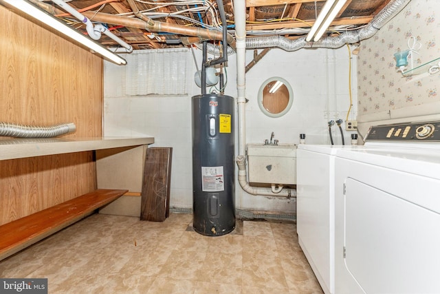 basement featuring washer and dryer, water heater, and sink