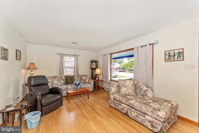 living room featuring a wealth of natural light and light hardwood / wood-style flooring