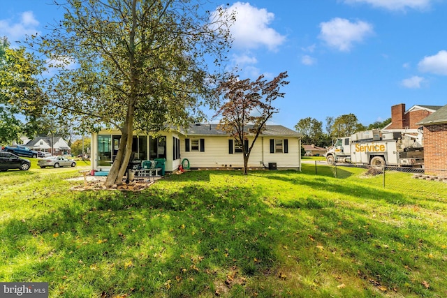 rear view of property featuring a yard