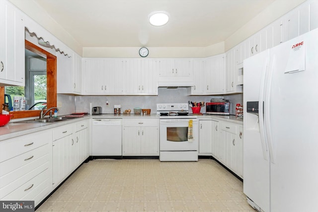 kitchen featuring sink, white appliances, and white cabinetry