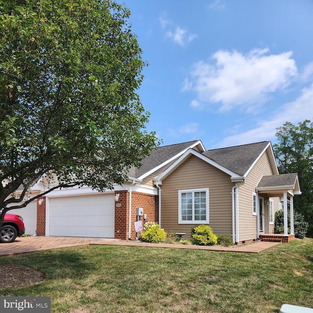 view of front of property featuring a garage and a front lawn